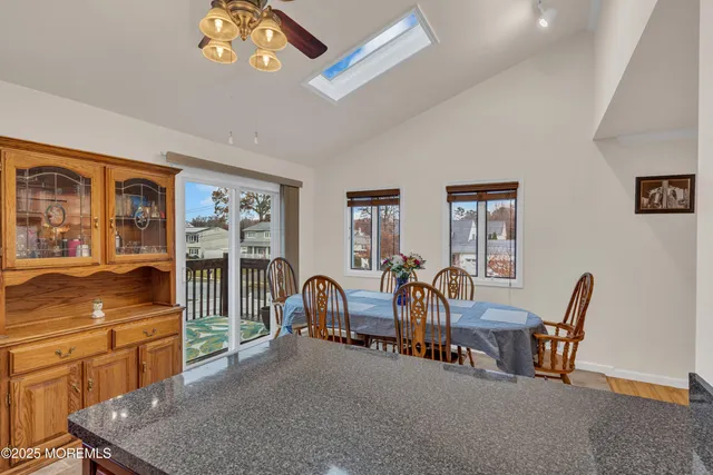 a view of a dining room with furniture a chandelier and wooden floor