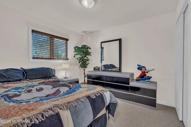 a bedroom with a bed and a potted plant