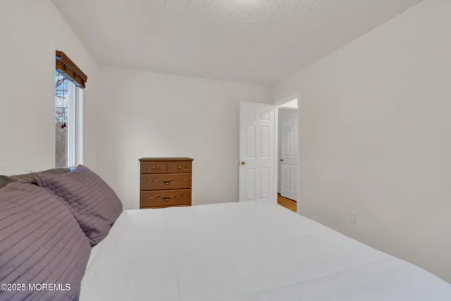 a bedroom with a bed and a cabinets