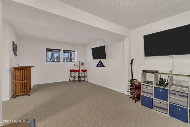 a view of a livingroom with furniture and a flat screen tv