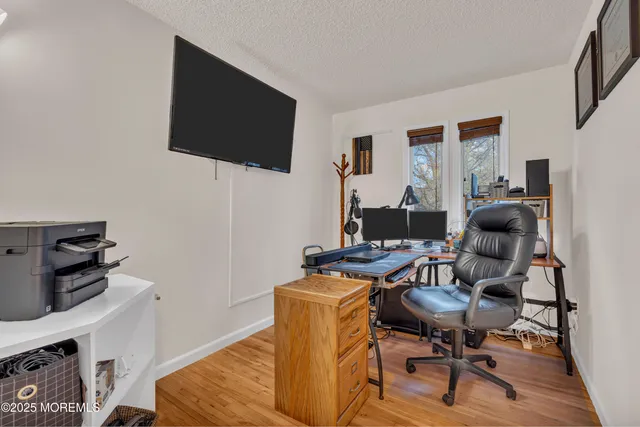 a work room with furniture and a flat screen tv