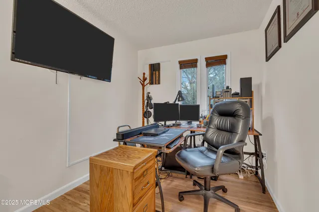 a work room with furniture and a flat screen tv