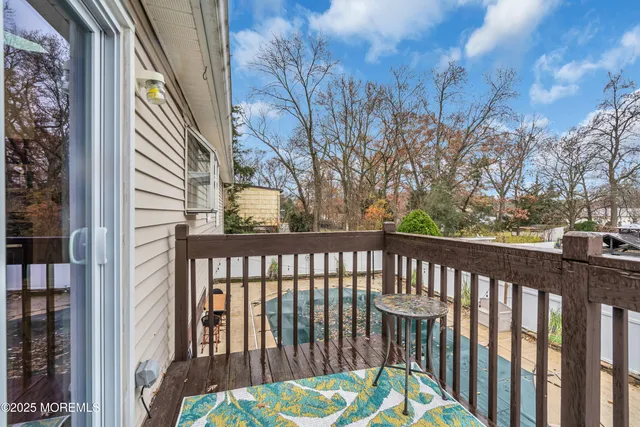 a view of a street with a trees from a balcony