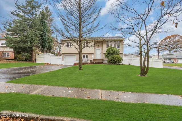 a view of a backyard with large trees