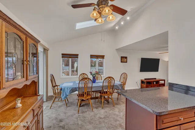 a view of a dining room with furniture and a flat screen tv
