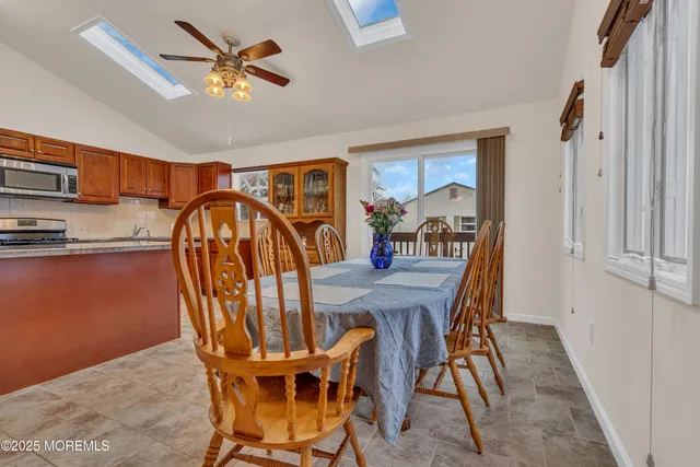 a dining room with furniture a rug and a chandelier