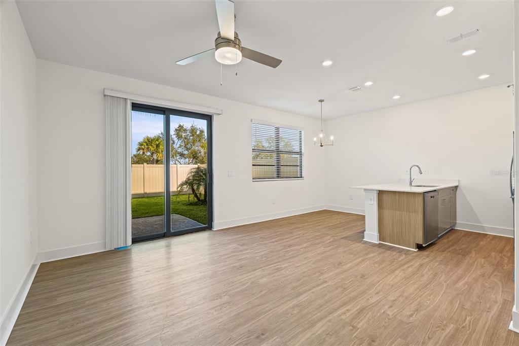 14456 Stellar Place Lakewood Ranch, FL 34202 - Photo 11 of 34 a view of an empty room with a window and wooden floor
