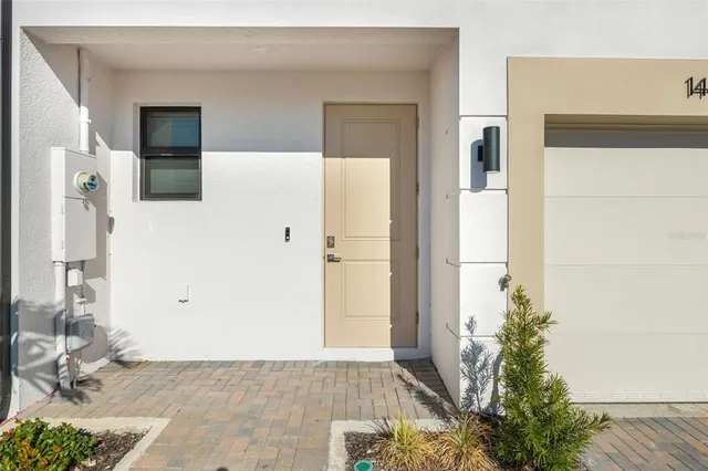 a view of a hallway with wooden floor and a living room