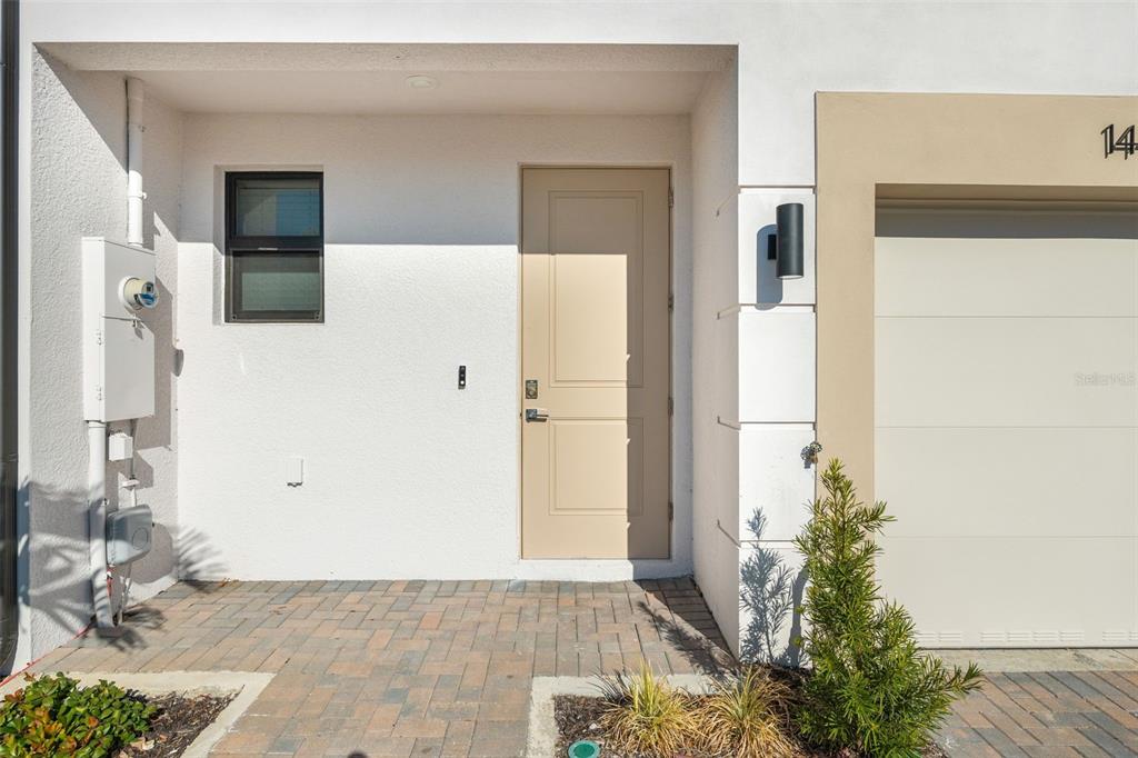 14456 Stellar Place Lakewood Ranch, FL 34202 - Photo 2 of 34 a view of a hallway with wooden floor and a living room