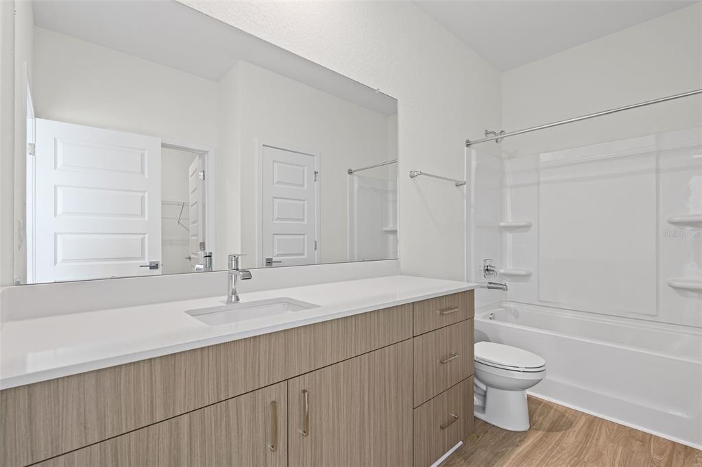 14456 Stellar Place Lakewood Ranch, FL 34202 - Photo 24 of 34 a bathroom with a sink toilet a vanity and bathtub