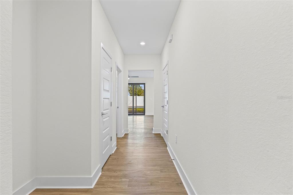 14456 Stellar Place Lakewood Ranch, FL 34202 - Photo 4 of 34 a view of a hallway with wooden floor