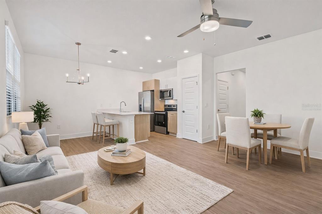 14456 Stellar Place Lakewood Ranch, FL 34202 - Photo 8 of 34 a living room with furniture and a wooden floor