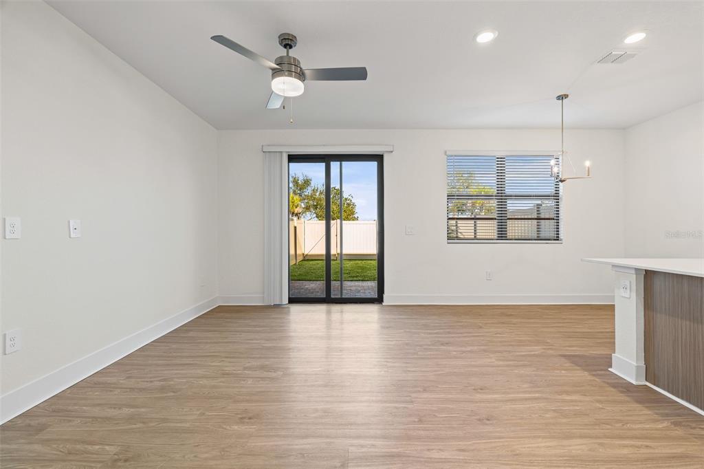 14456 Stellar Place Lakewood Ranch, FL 34202 - Photo 9 of 34 a view of an empty room with a window and wooden floor