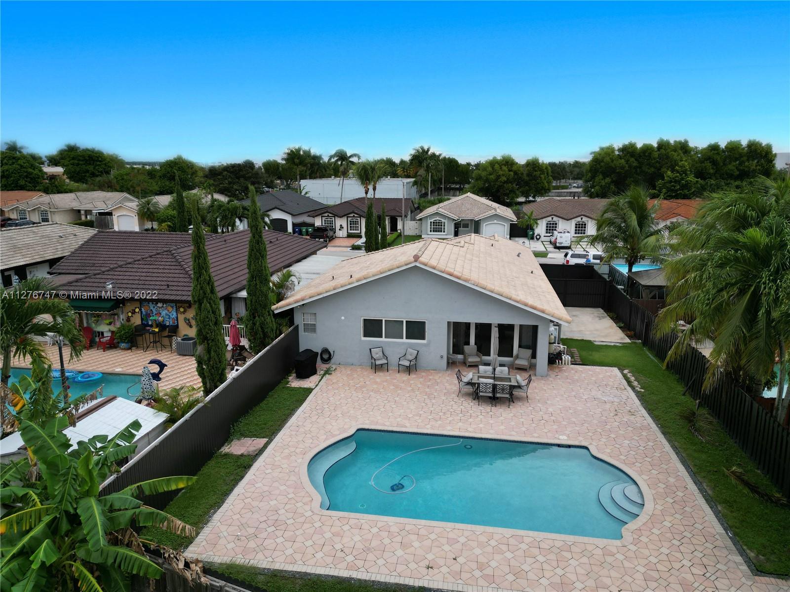 an aerial view of a house with swimming pool garden view and mountains
