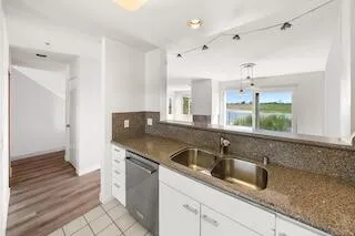 a kitchen with stainless steel appliances granite countertop a sink and a granite counter tops