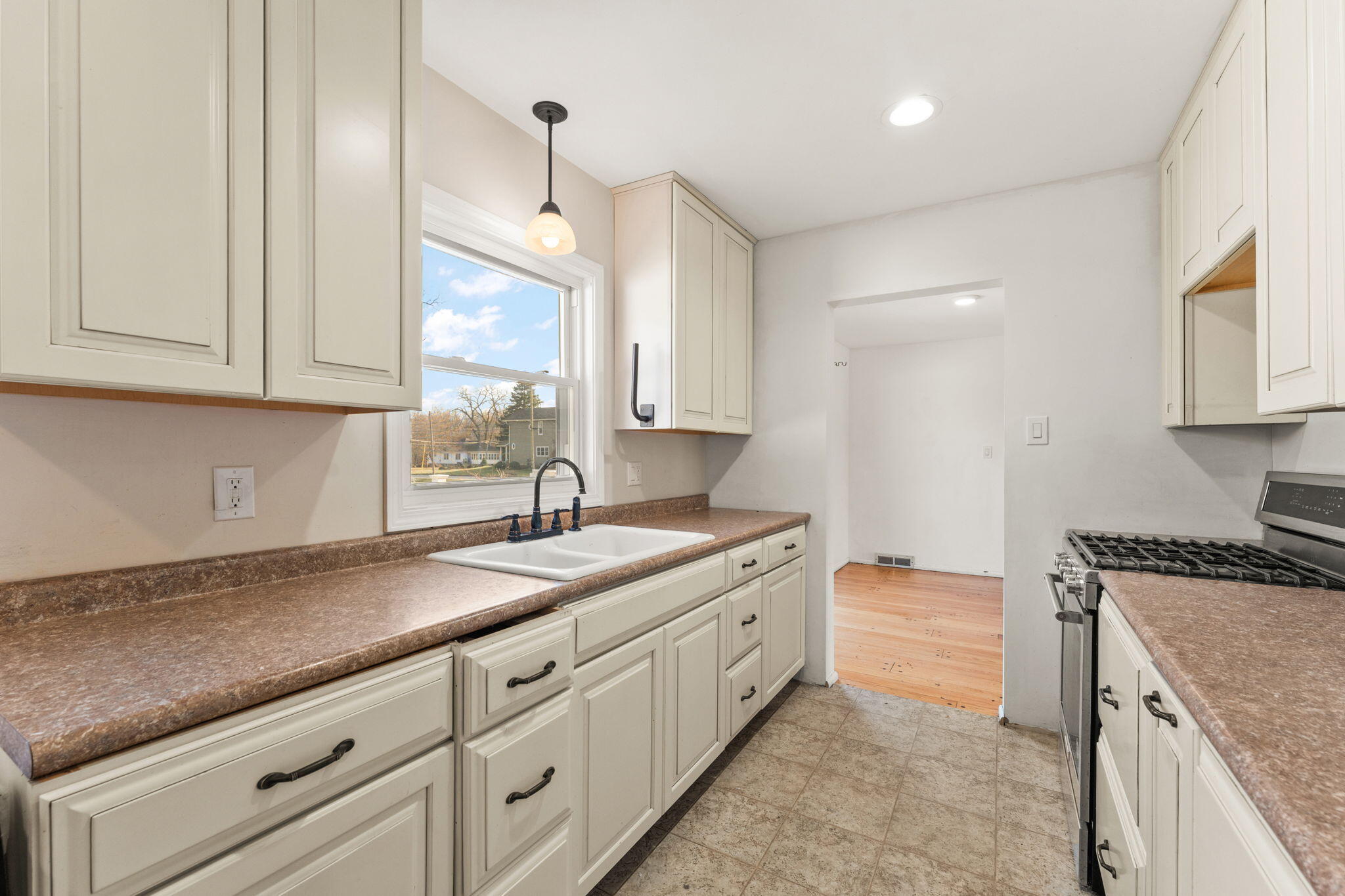 323 South Home Avenue Rensselaer, IN 47978 - Photo 11 of 20 a kitchen with granite countertop a sink a stove and cabinets