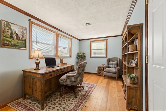 a living room with furniture and a piano
