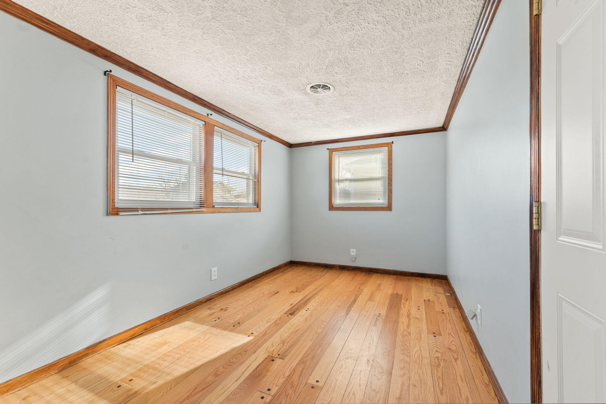 323 South Home Avenue Rensselaer, IN 47978 - Photo 17 of 20 a view of an empty room with wooden floor and a window