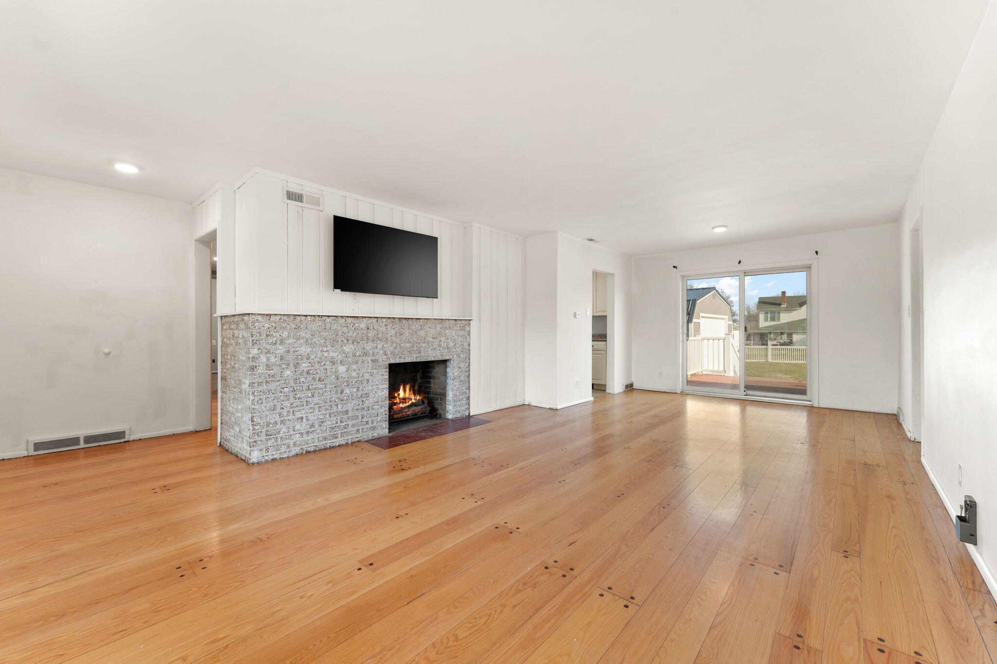 323 South Home Avenue Rensselaer, IN 47978 - Photo 4 of 20 a view of empty room with wooden floor and fireplace