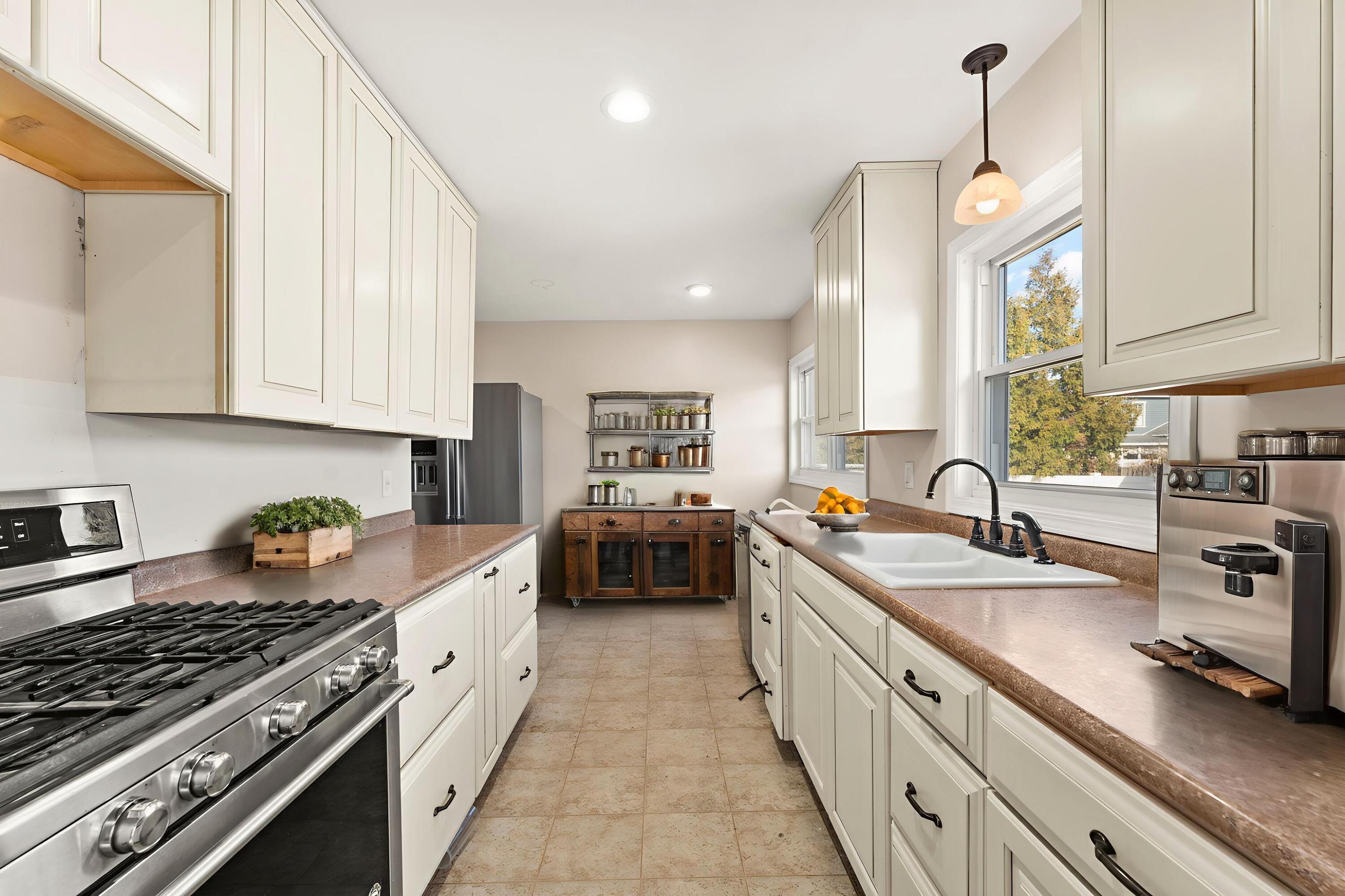 323 South Home Avenue Rensselaer, IN 47978 - Photo 7 of 20 a large kitchen with stainless steel appliances granite countertop a lot of counter space a sink dishwasher and cabinets with wooden floor