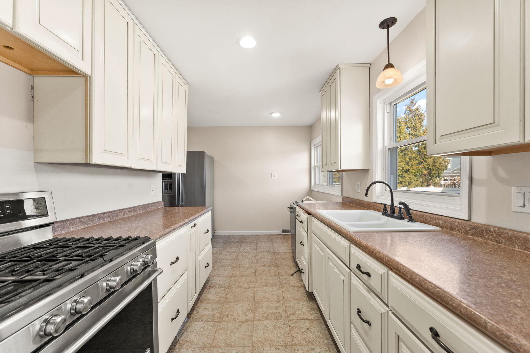 323 South Home Avenue Rensselaer, IN 47978 - Photo 8 of 20 a large kitchen with stainless steel appliances granite countertop a sink and a stove