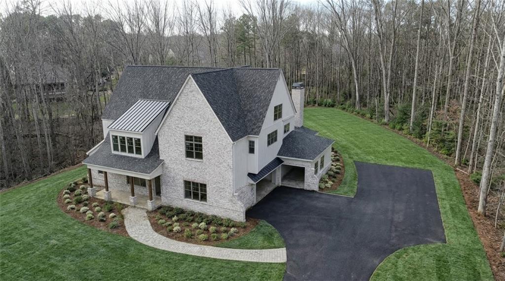 879 Arnold Mill Road Woodstock, GA 30188 - Photo 2 of 9 a aerial view of a house next to a yard