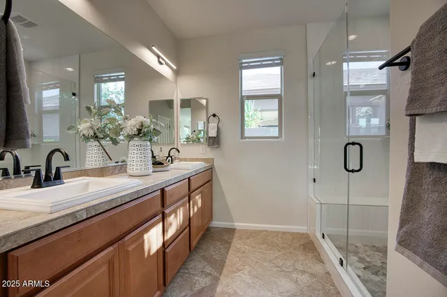 a bathroom with a double vanity sink and a mirror
