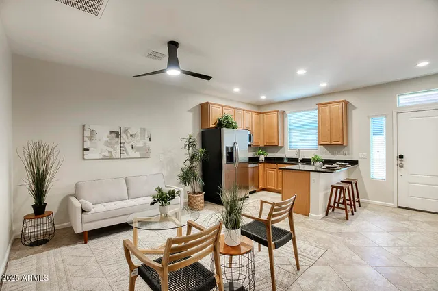 a kitchen with stainless steel appliances kitchen island granite countertop a refrigerator and a stove top oven