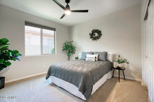 a bedroom with a bed and a potted plant
