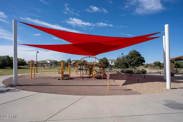 a view of a street with couches and wooden fence