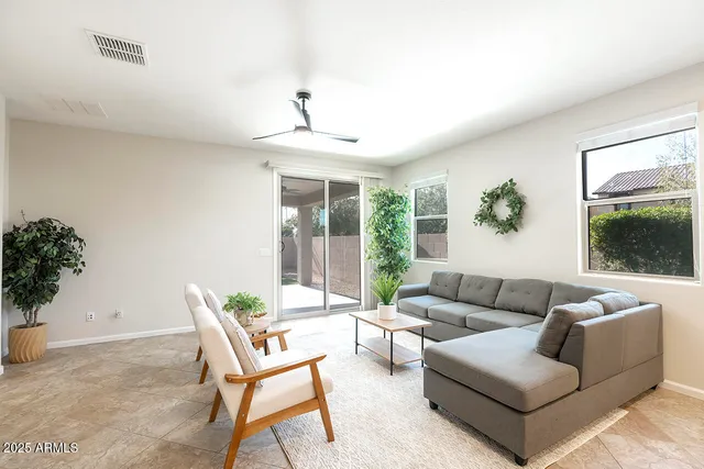 a living room with furniture and a large window
