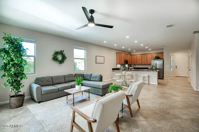 a living room with furniture and kitchen view