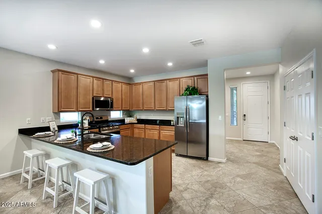 a kitchen with refrigerator and cabinets
