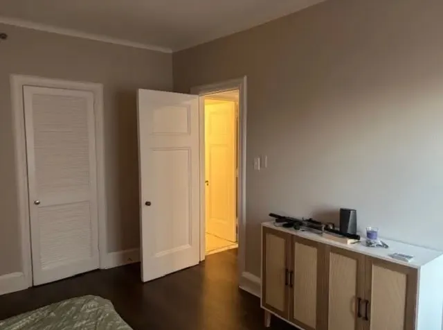 a view of a hallway with wooden floor and closet