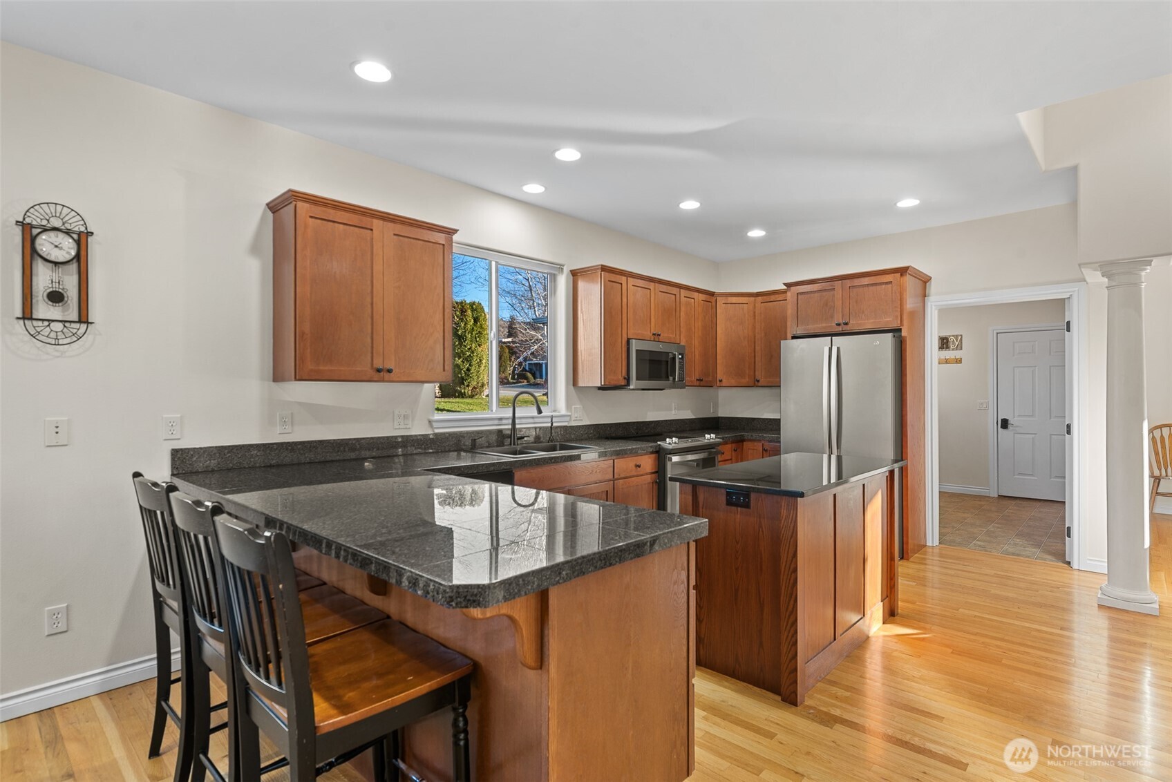 105 Cascade Place Cashmere, WA 98815 - Photo 15 of 39 a kitchen with stainless steel appliances granite countertop a table chairs sink and refrigerator