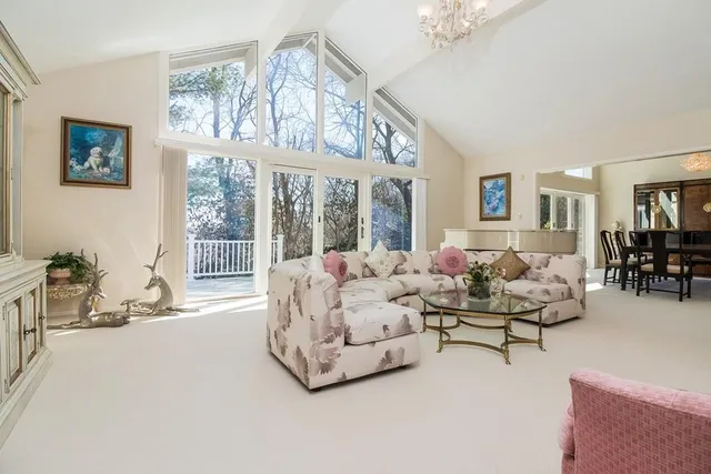 a living room with furniture and large windows