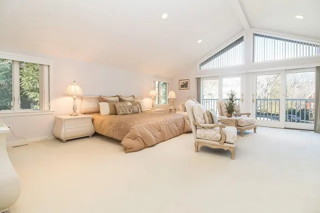 a bedroom with a bed and a large window