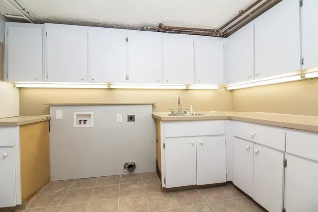 a view of an empty room with a cabinet