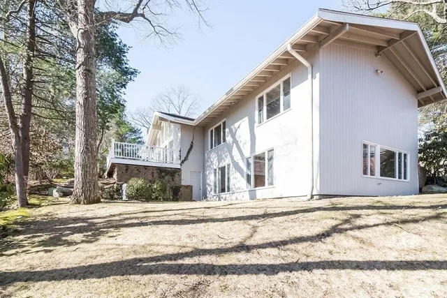 a front view of a house with a yard and outdoor seating