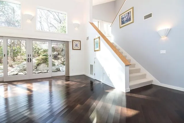 a view of an entryway with wooden floor