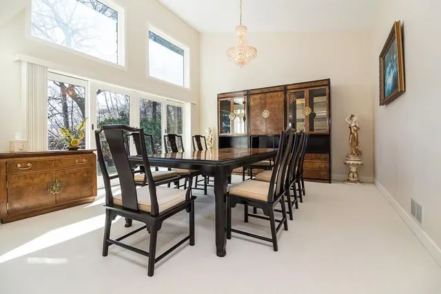 a view of a dining room with furniture and chandelier