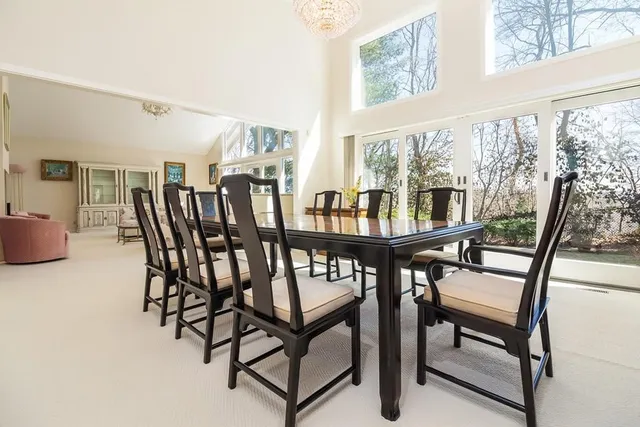 a view of a dining room with furniture and a window
