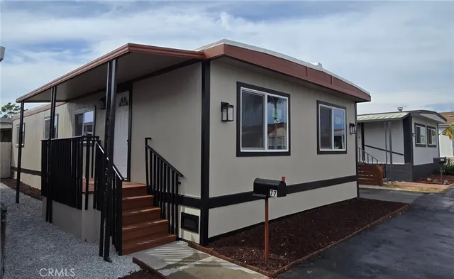 a view of a house with wooden walls and stairs