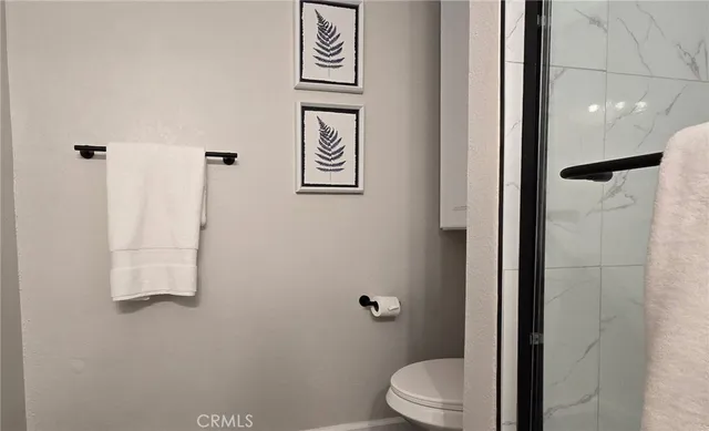 a white toilet sitting next to a bathroom sink