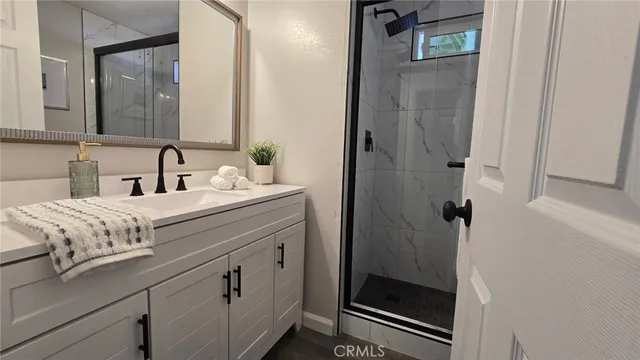 a bathroom with a sink a mirror and shower