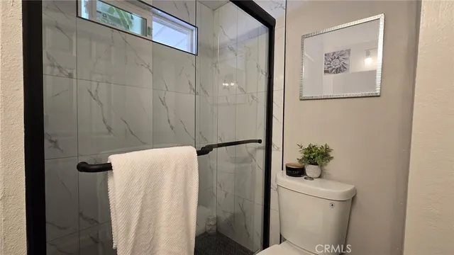 a bathroom with a toilet and a shower curtain