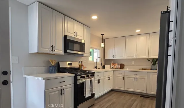 a kitchen with a sink a stove and cabinets