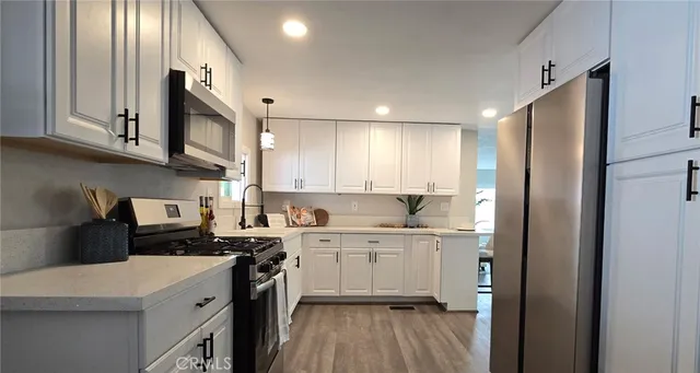 a kitchen with a sink a stove top oven and cabinets