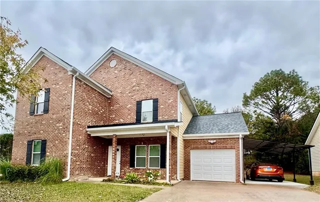 a front view of a house with yard