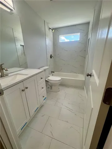 a bathroom with a double vanity sink toilet and shower